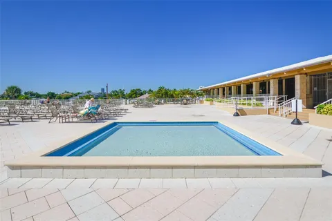 a view of swimming pool with a yard and mountain view