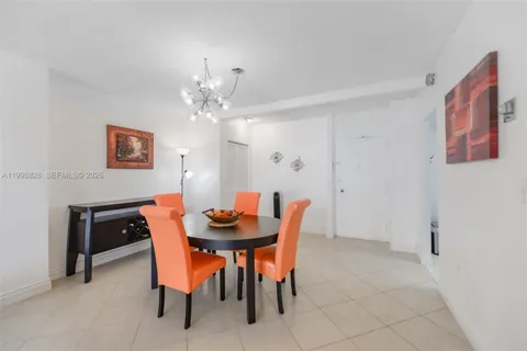 a dining room with furniture and chandelier