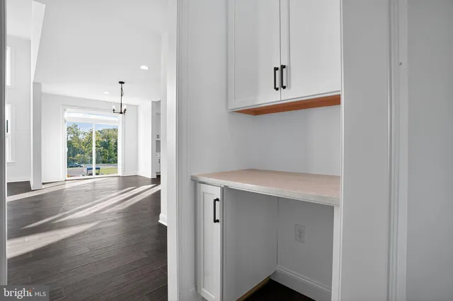 a view of empty room with wooden floor and fireplace