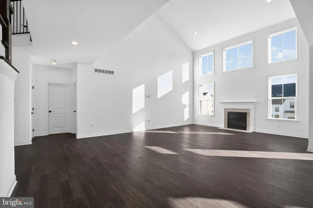 a view of a livingroom with wooden floor and staircase