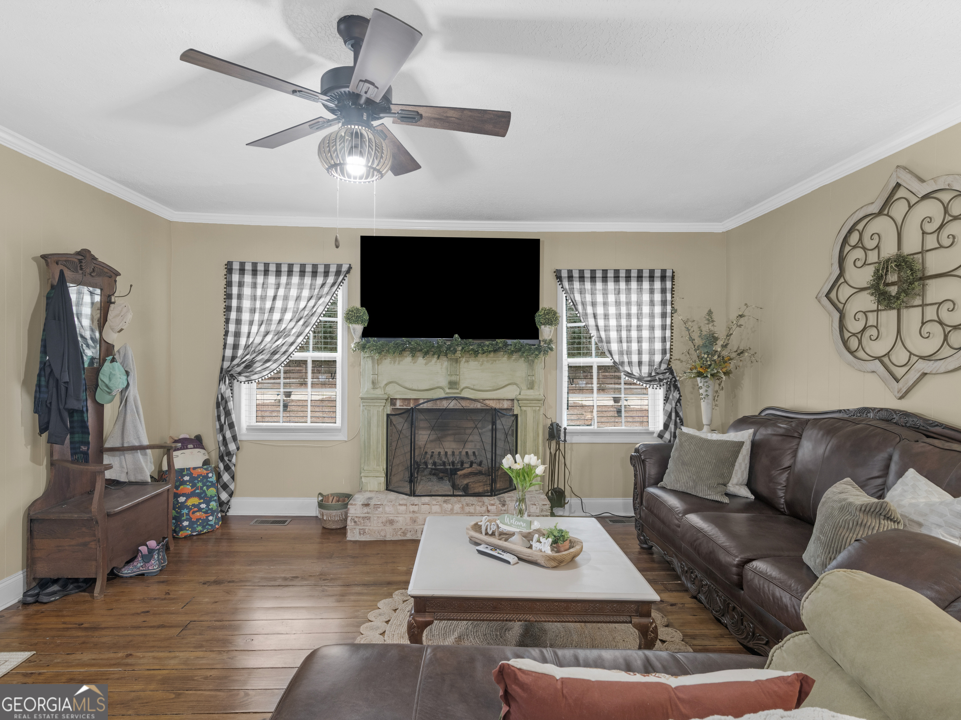 120 Ellerbee Lake Road Thomaston, GA 30286 - Photo 3 of 23 a living room with furniture a fireplace and a flat screen tv