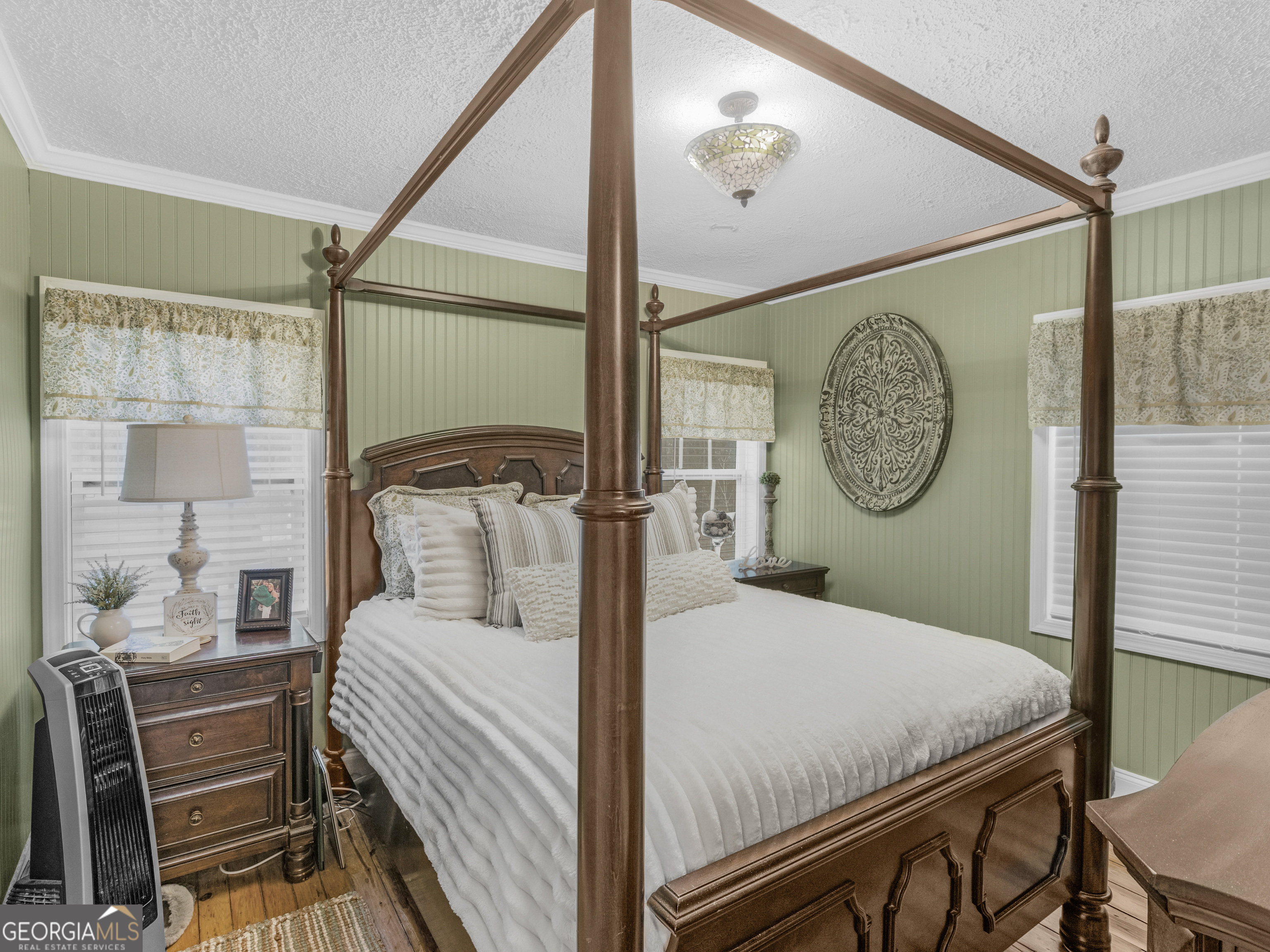 120 Ellerbee Lake Road Thomaston, GA 30286 - Photo 9 of 23 a bedroom with a bed a mirror on the wall and a large window