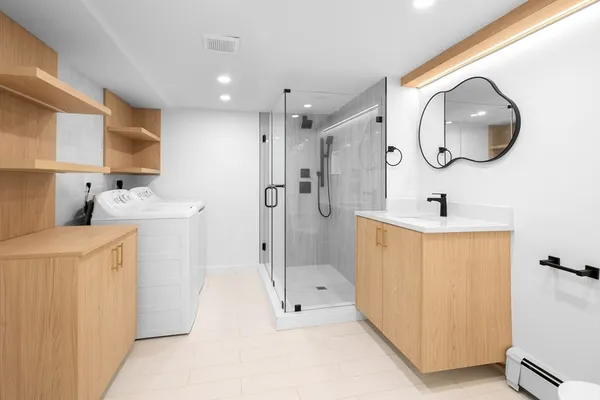 a bathroom with a sink a mirror and a shower