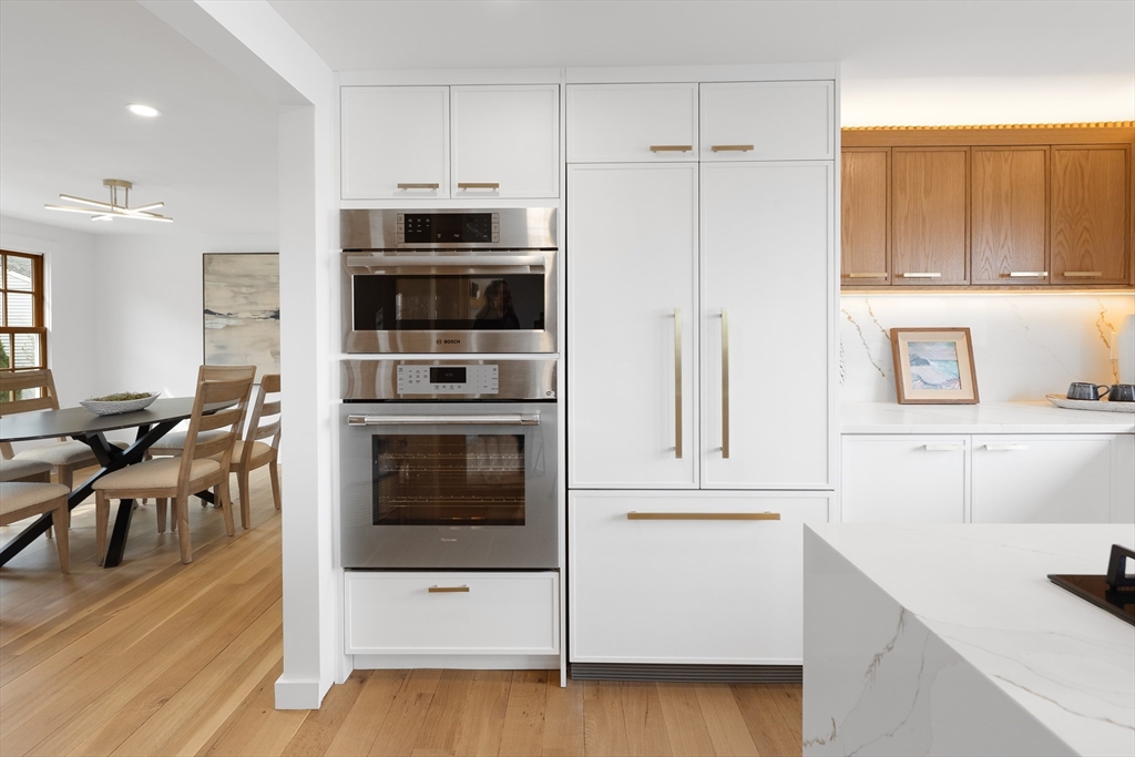 8 Pine Tree Drive Wareham, MA 02532 - Photo 5 of 35 a kitchen with stainless steel appliances a stove a microwave and white cabinets