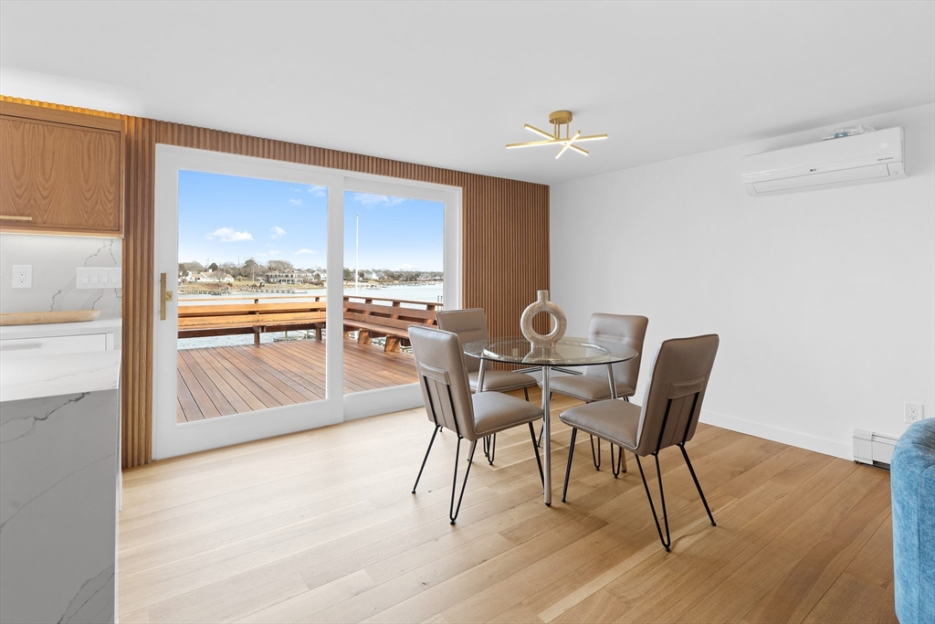 8 Pine Tree Drive Wareham, MA 02532 - Photo 10 of 35 a dining room with furniture a chandelier and wooden floor
