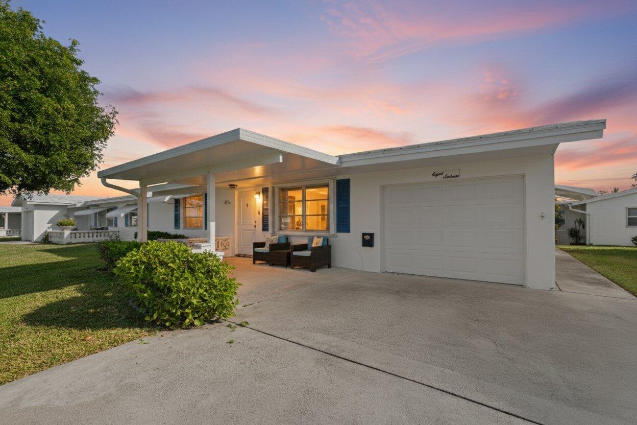 816 Southwest 18th Court Boynton Beach, FL 33426 - Photo 1 of 37 a front view of a house with a yard and garage
