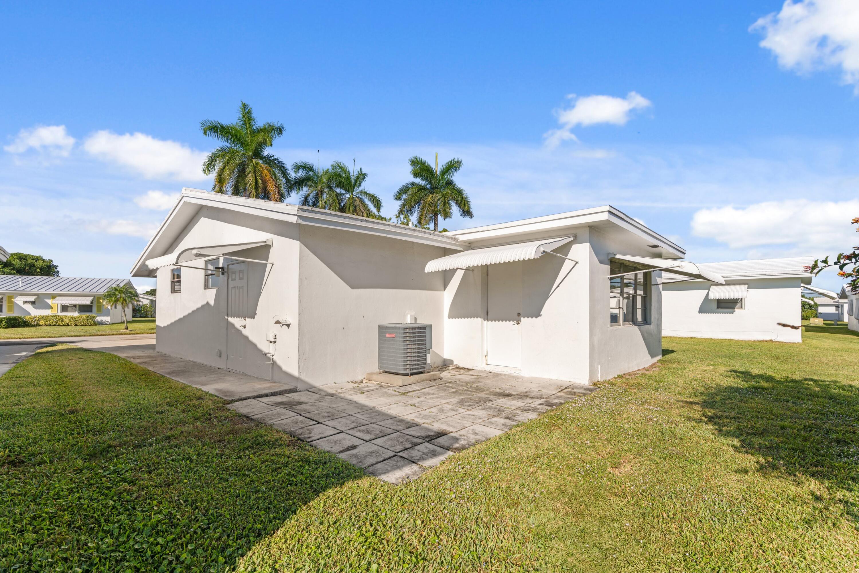 816 Southwest 18th Court Boynton Beach, FL 33426 - Photo 14 of 37 a front view of a house with a yard