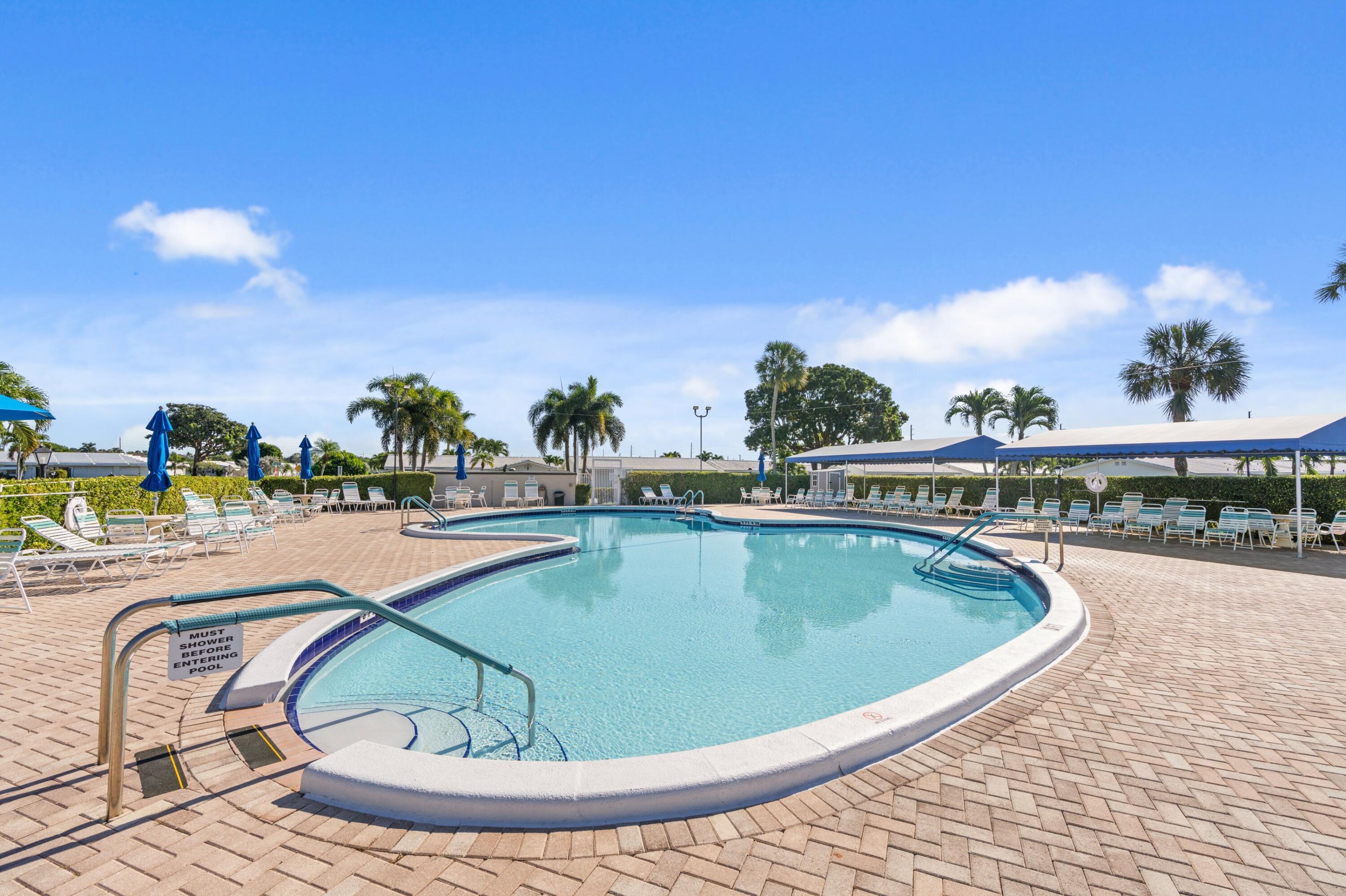 816 Southwest 18th Court Boynton Beach, FL 33426 - Photo 19 of 37 a view of a swimming pool with a lounge chair