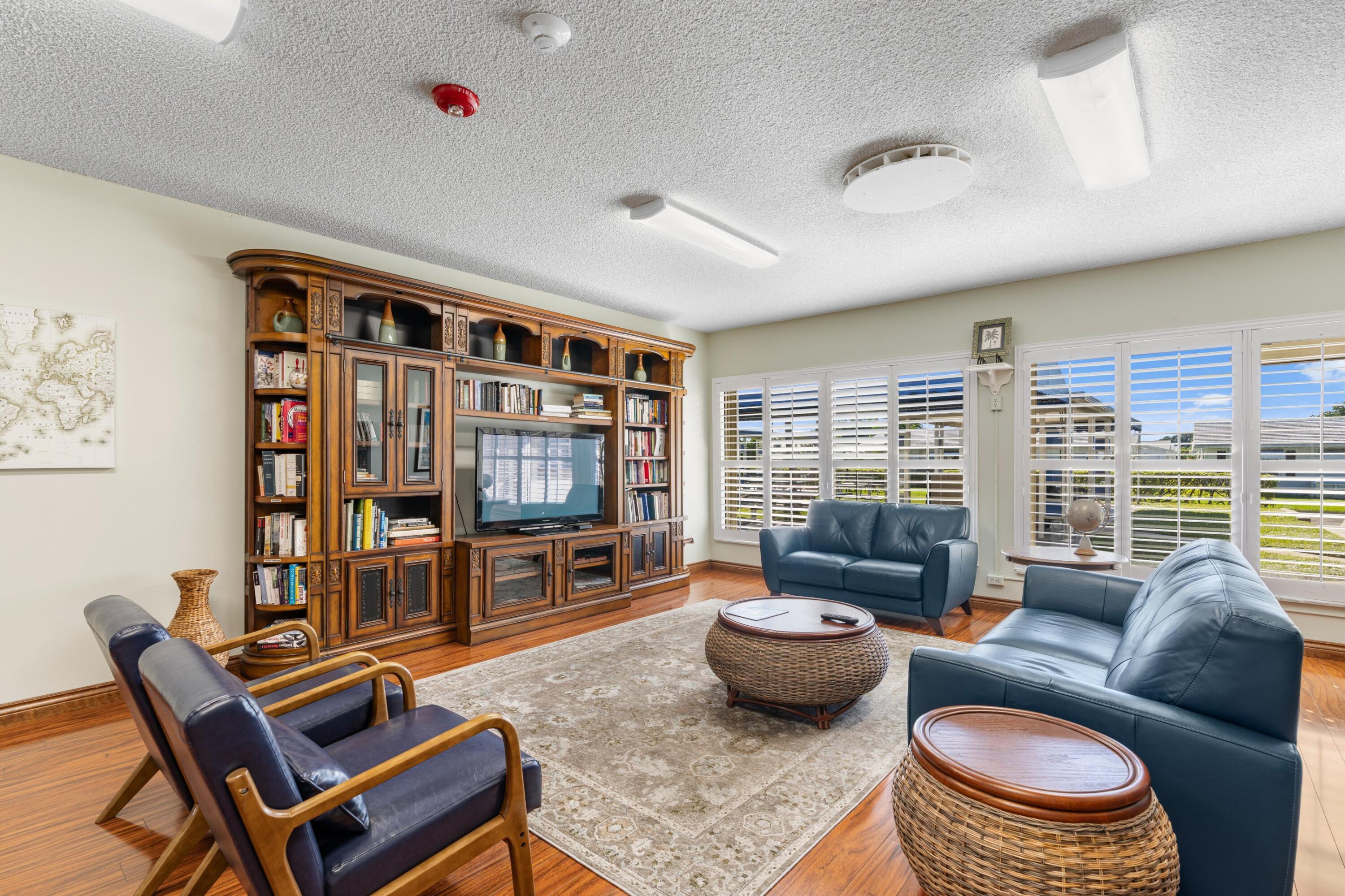 816 Southwest 18th Court Boynton Beach, FL 33426 - Photo 23 of 37 a living room with furniture and a flat screen tv