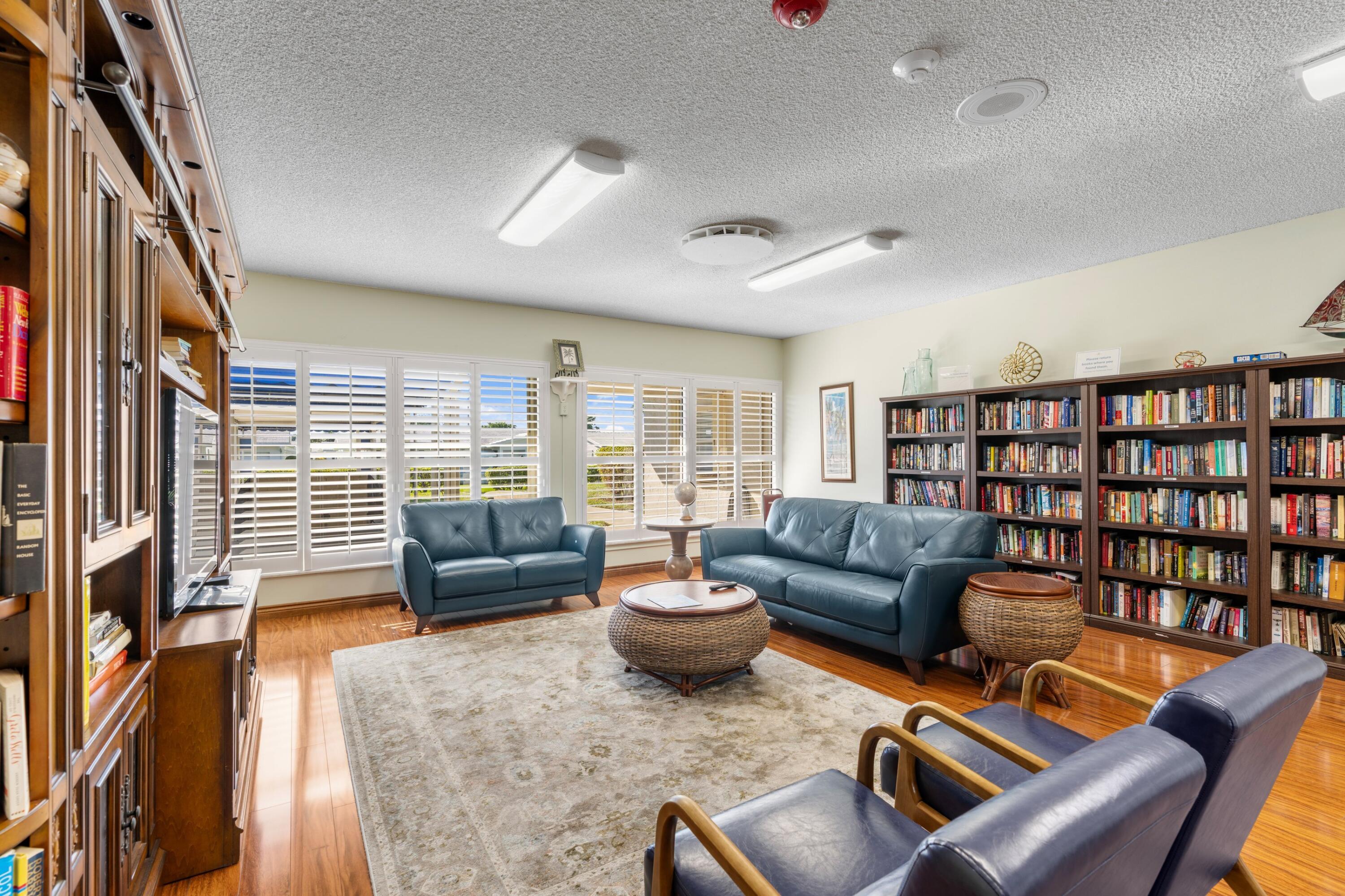 816 Southwest 18th Court Boynton Beach, FL 33426 - Photo 24 of 37 a living room with furniture and a book shelf