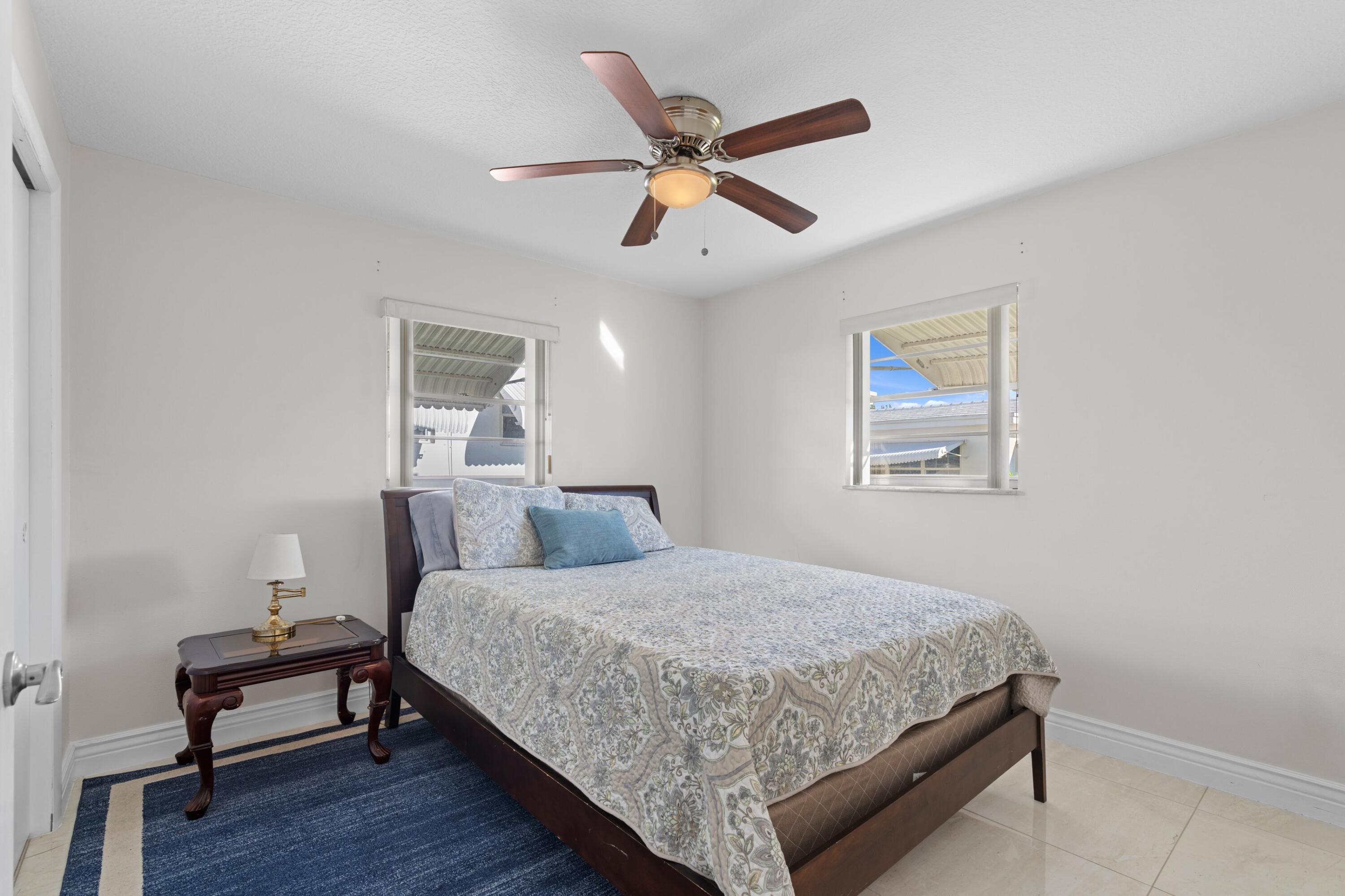 816 Southwest 18th Court Boynton Beach, FL 33426 - Photo 10 of 37 a bedroom with a bed and window