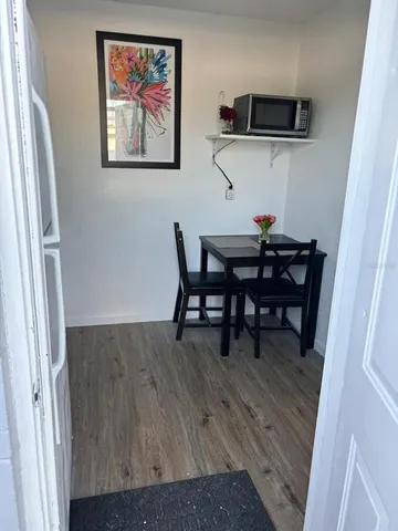 a view of wooden floor and windows in a room