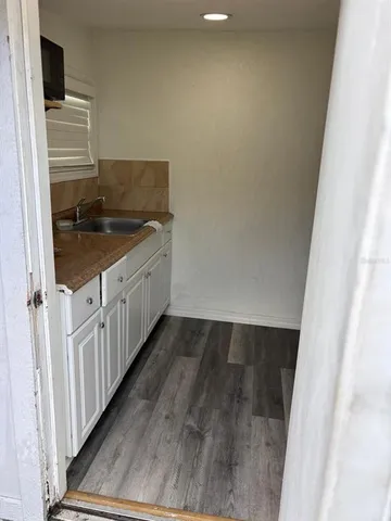 a view of front door with wooden floor
