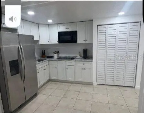 a kitchen with stainless steel appliances a refrigerator sink and cabinets