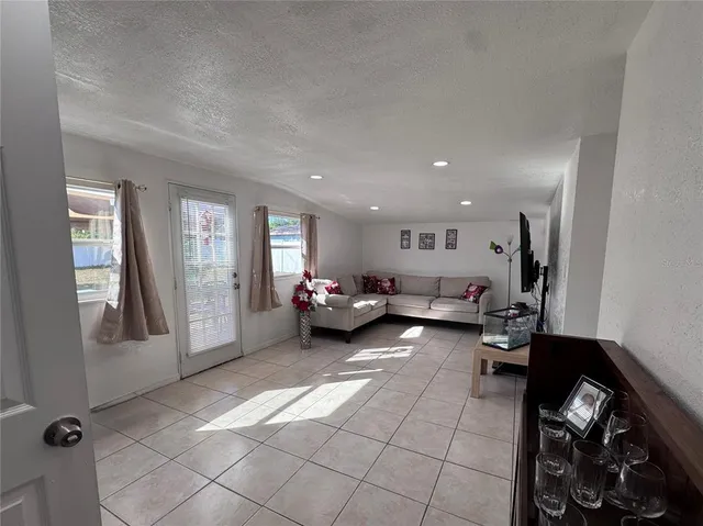 a spacious bedroom with a bed and a lamp