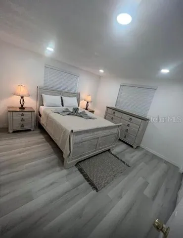 a bedroom with bed and a night stand