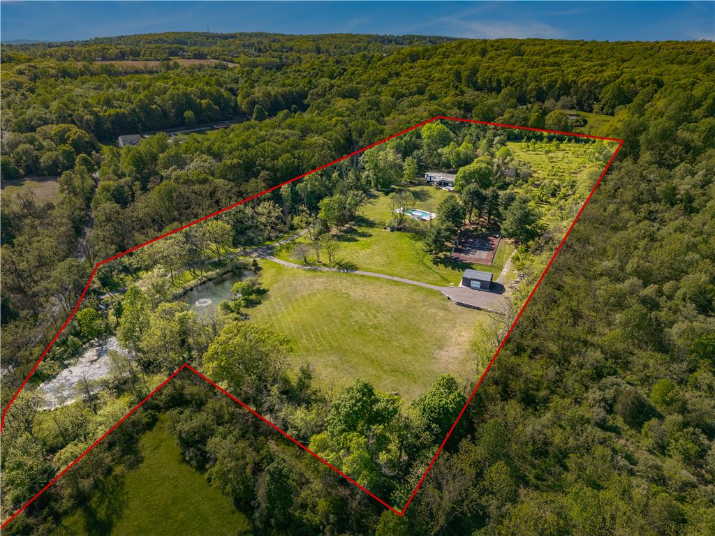 1506 Pleasant View Road Coopersburg, PA 18036 - Photo 96 of 97 An aerial panorama reveals a vast, verdant estate featuring a main residence, refreshing pool, and inviting tennis court amidst flourishing trees.