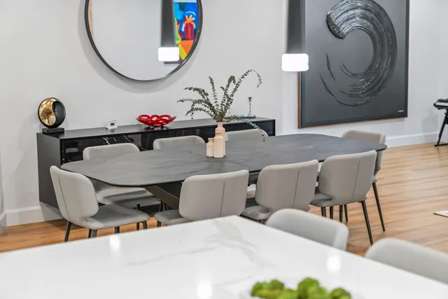 a view of kitchen with kitchen island stainless steel appliances refrigerator stove dining table and chairs