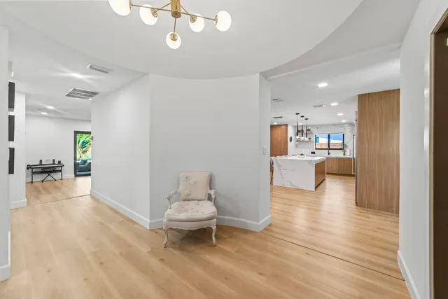 a bedroom with a large bed and a chandelier