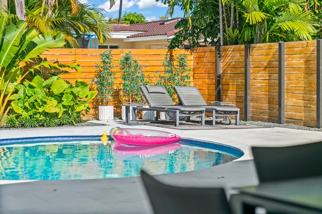 a view of a dining room with furniture a rug and a large window