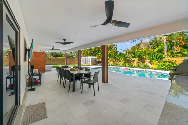 a view of a house with a yard and a large tree