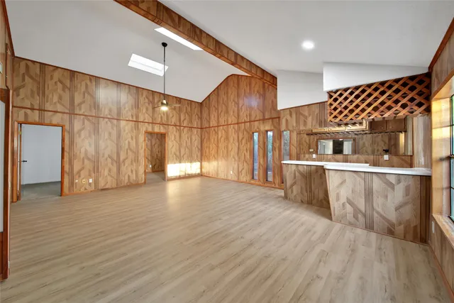 a view of a room with wooden floor