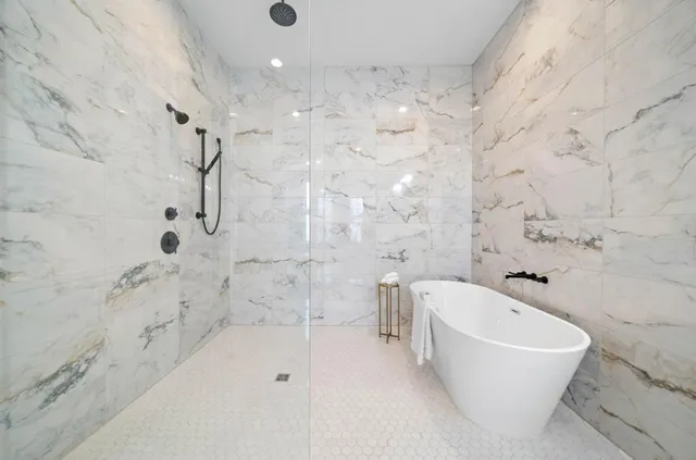 a bathroom with a bathtub and shower
