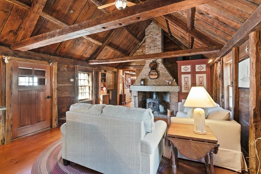 220 Prospect Street Hingham, MA 02043 - Photo 15 of 41 a living room with furniture a fireplace and a table