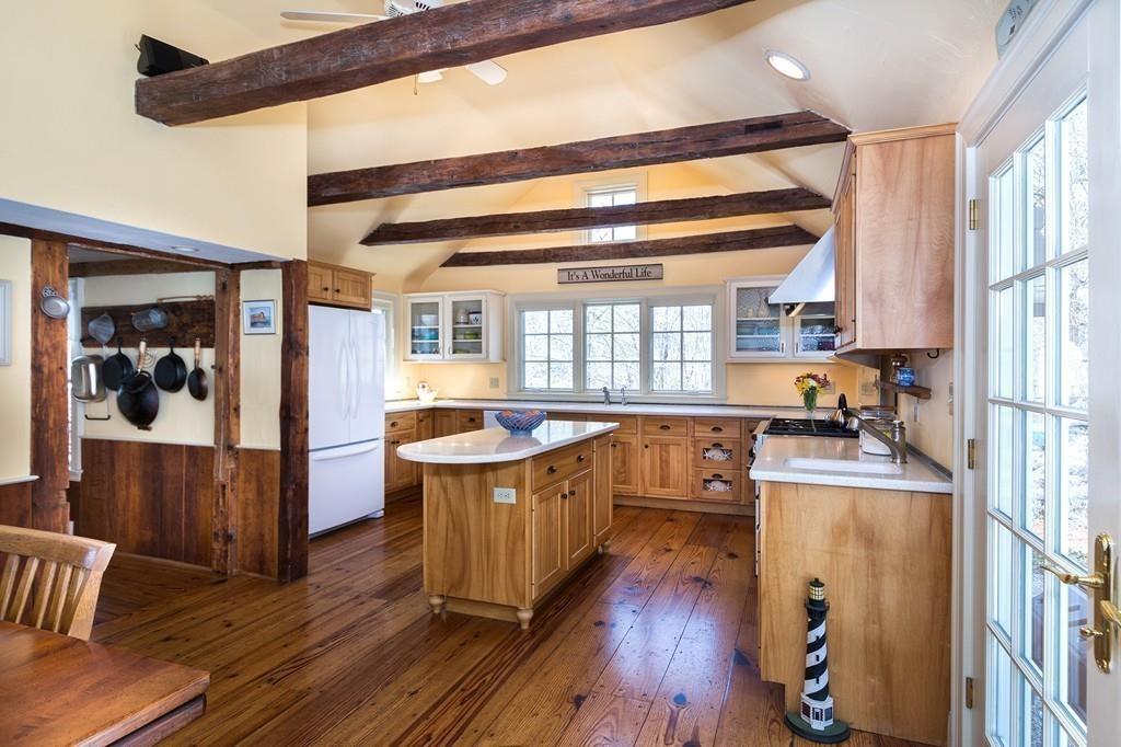 220 Prospect Street Hingham, MA 02043 - Photo 6 of 41 a kitchen with kitchen island wooden floors wooden cabinets and stainless steel appliances