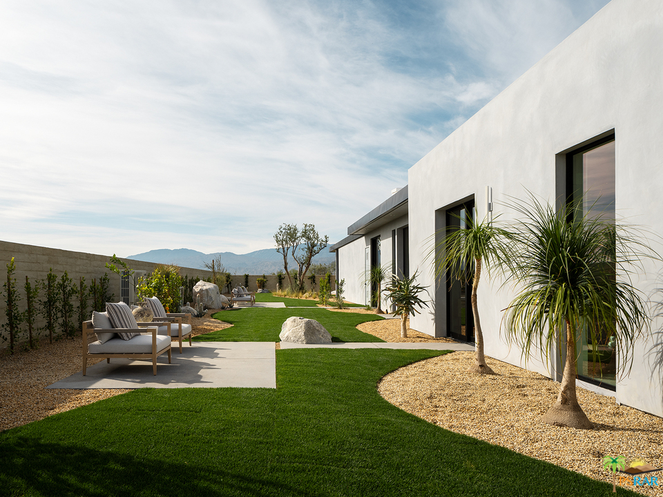 2 Echo Lane Rancho Mirage, CA 92270 - Photo 4 of 40 a view of a backyard with lawn chairs potted plants and palm trees
