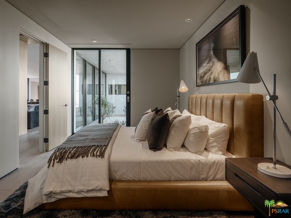 2 Echo Lane Rancho Mirage, CA 92270 - Photo 5 of 40 a bedroom with a bed and glass window