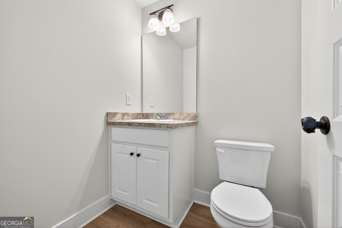 206 Airport Road, Unit 11 Canon, GA 30520 - Photo 20 of 34 a bathroom with a granite countertop toilet and a sink