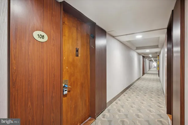 a view of a hallway with wooden door