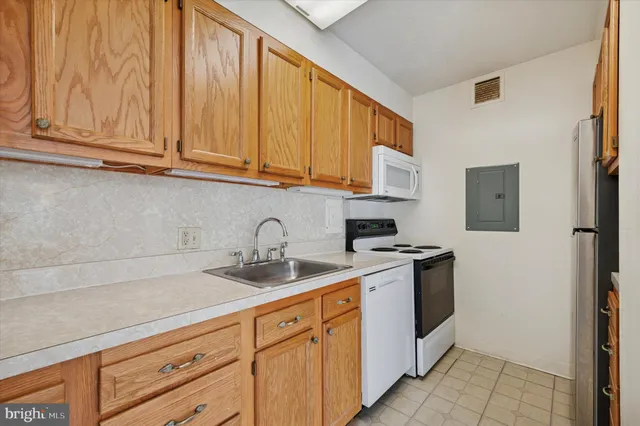 a kitchen with stainless steel appliances granite countertop a sink and a white cabinets