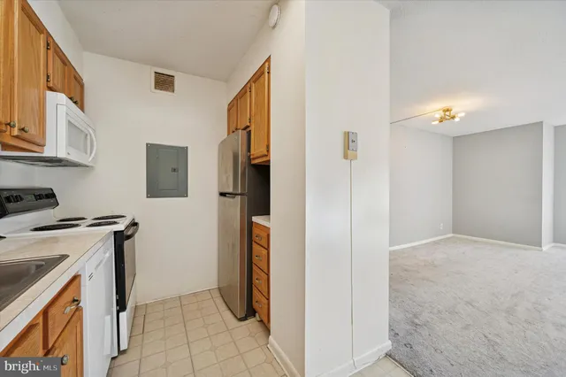 a utility room with cabinets washer and dryer