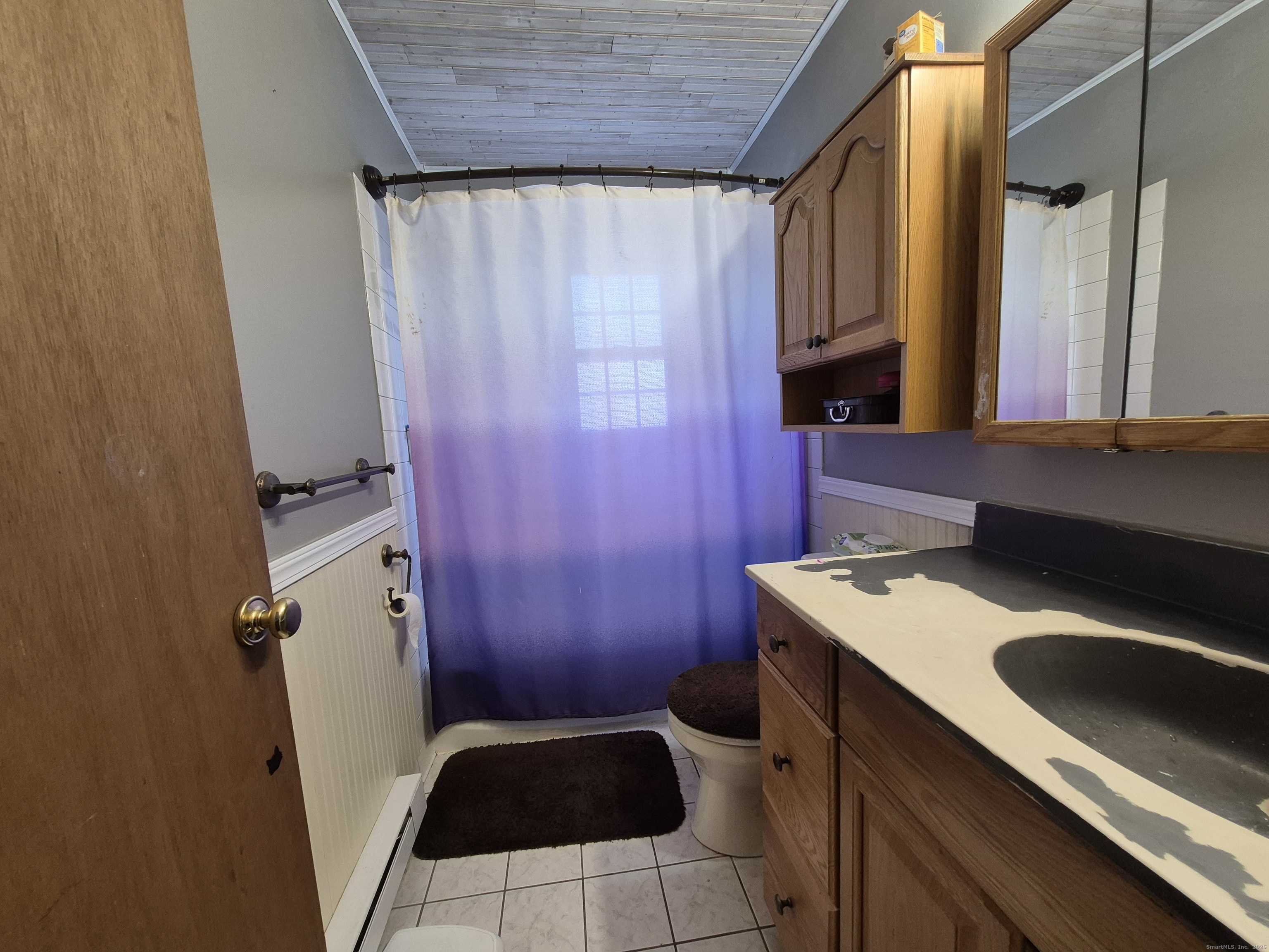 74 Athol Street, Unit 74 Killingly, CT 06239 - Photo 11 of 15 a bathroom with a sink a toilet and shower