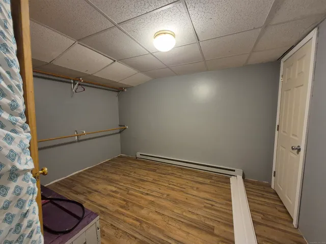 a view of a room with wooden floor