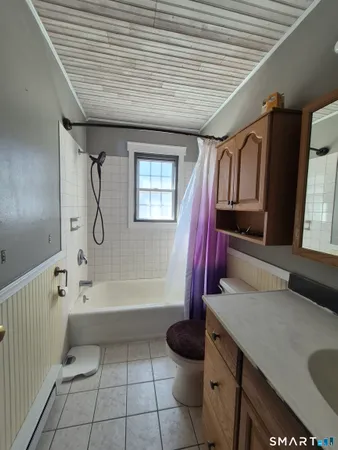 a bathroom with a sink a toilet and bathtub
