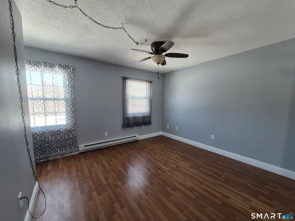 wooden floor in an empty room with a window