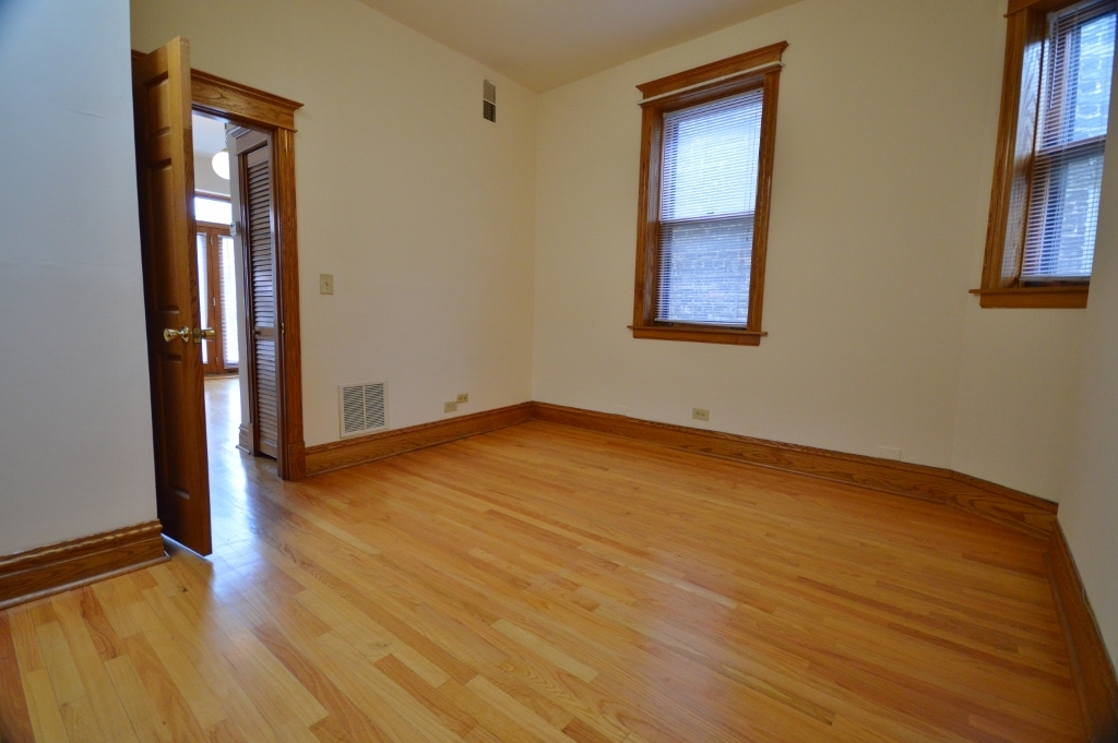 713 West Wrightwood Avenue, Unit 2R Chicago, IL 60614 - Photo 6 of 8 a view of an empty room with wooden floor and a window