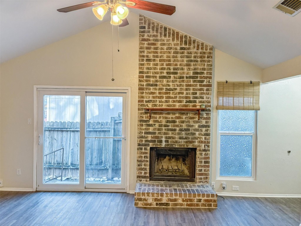 a living room with a fireplace and a wooden floor