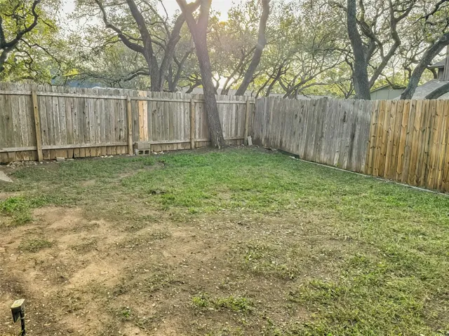 a view of backyard with wooden fences