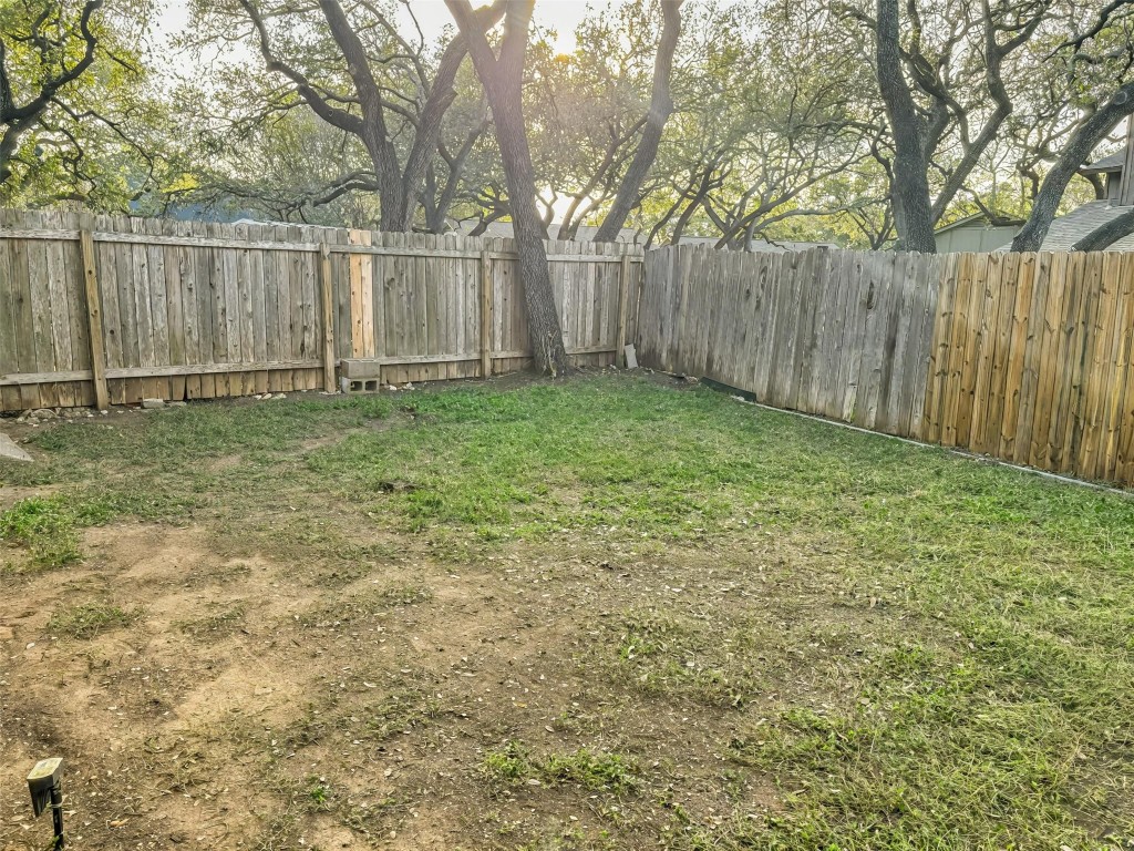 7006 Ivory Key Court, Unit A Austin, TX 78745 - Photo 15 of 16 a view of backyard with wooden fences