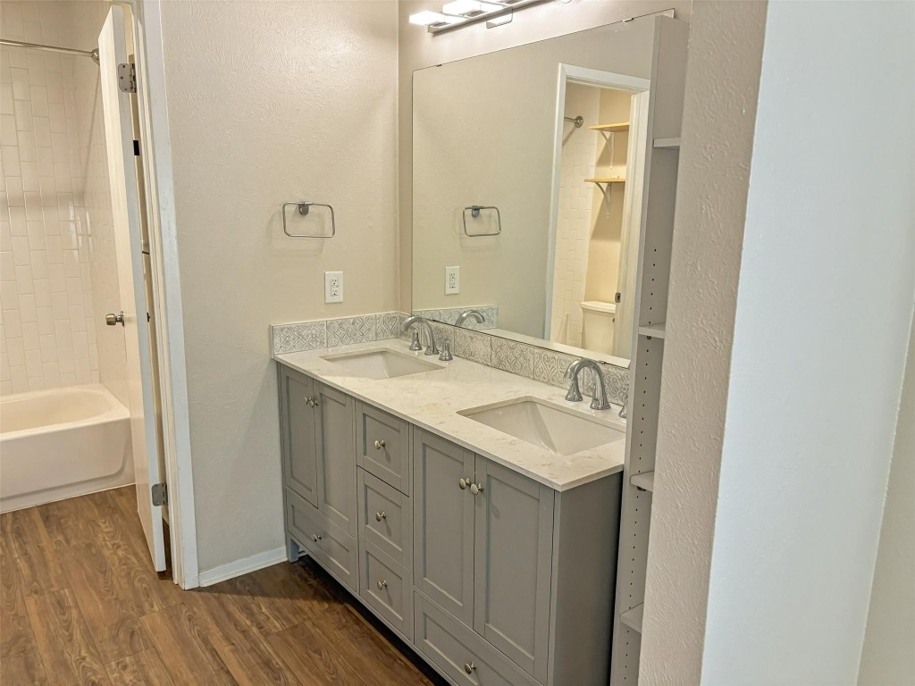 7006 Ivory Key Court, Unit A Austin, TX 78745 - Photo 8 of 16 a bathroom with a sink a mirror and a bathtub