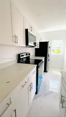 a kitchen with stainless steel appliances a stove and a refrigerator