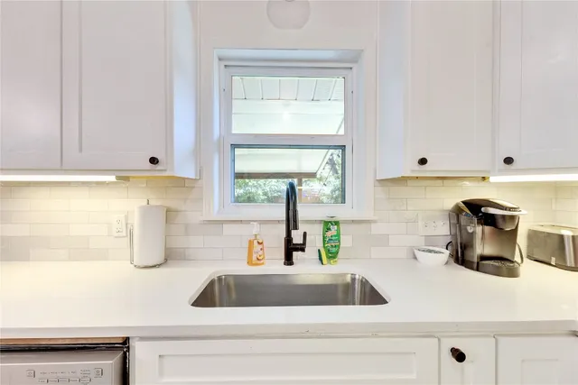 a kitchen with a sink and a window