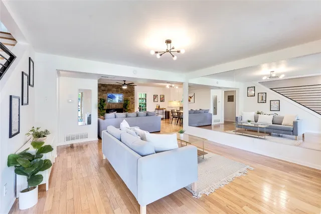 a living room with furniture and a chandelier