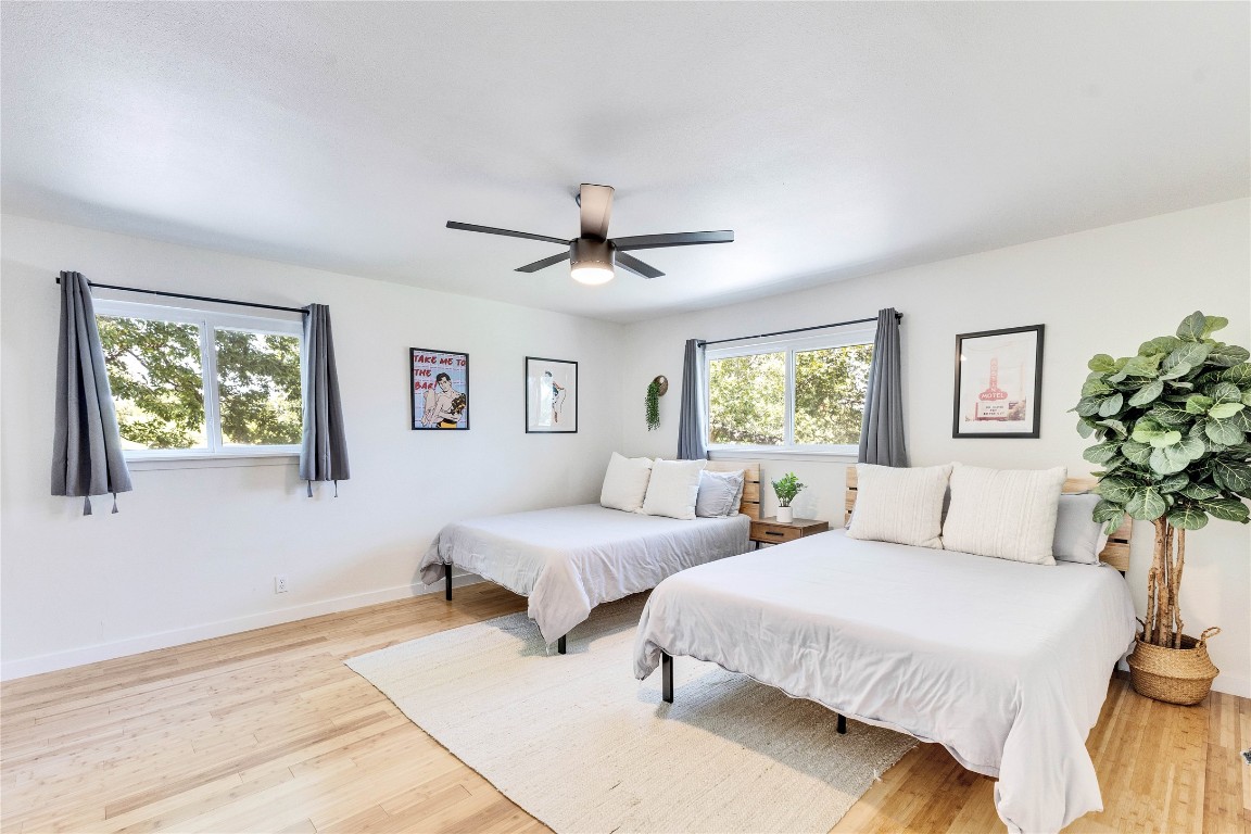 3306 South Pleasant Valley Road Austin, TX 78741 - Photo 19 of 28 a bedroom with two beds and a potted plant