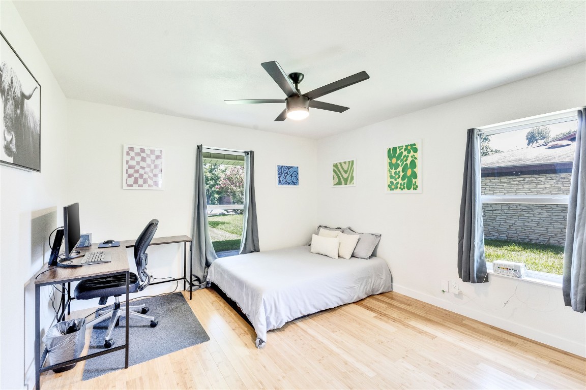 3306 South Pleasant Valley Road Austin, TX 78741 - Photo 23 of 28 a bedroom with a bed a desk and chair with window