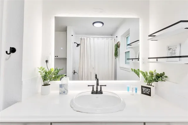 a bathroom with a sink a vanity and a mirror